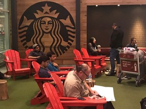 People wait outside a Starbucks cafe for passengers arriving at Pearson international airport in Toronto, Ontario, Canada June 13, 2018.