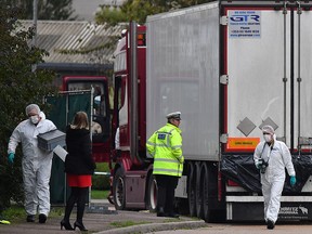 In this file photo taken on October 23, 2019 British police forensics officers work on a truck found to be containing 39 dead bodies, at Waterglade Industrial Park in Grays, on October 23, 2019. (BEN STANSALL/AFP via Getty Images)