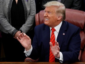 President Donald Trump reacts to a question from a reporter following a signing ceremony for the Supporting Veterans in STEM Careers Act inside the Oval Office of the White House in Washington, February 11, 2020. (REUTERS/Tom Brenner)