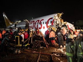 Rescue workers and firefighters attend the scene after a Pegasus Airlines plane skidded off the runway at Istanbul's Sabiha Gokcen Airport in Istanbul, Turkey, on Feb. 5, 2020.