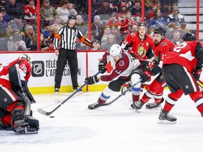 Valeri Nichushkin of the Colorado Avalanche drives to the net as Senators’ Nick Paul tries to slow him down during the second period of Thursday night’s game at the Canadian Tire Centre.