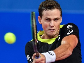 Vasek Pospisil returns the ball to Gael Montfils during the final at the Open Sud de France ATP World Tour in Montpellier, France, on Sunday, Feb. 9, 2020.