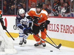 Jakub Voracek of the Philadelphia Flyers controls the puck against Tucker Poolman of the Winnipeg Jets in the third period at the Wells Fargo Center on Saturday afternoon.