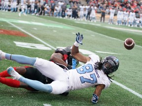 Chris Randle of the Ottawa Redblacks blocks the pass to Derel Walker of the Toronto Argonauts last season. (Jana Chytilova photo)