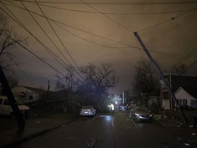 A resident makes her way down Underwood St. amidst downed trees and heavy debris on March 3, 2020 in Nashville, Tennessee. A tornado passed through Nashville just after midnight leaving a wake of damage in its path including two people killed in East Nashville.