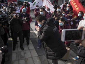 A discharged COVID-19 patient bows to the doctors while leaving Wuchang Fang Cang makeshift hospital, which is the latest temporary hospital being shut down, on March 10, 2020 in Wuhan, Hubei province, China.