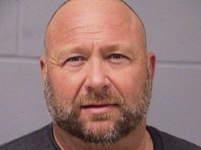 In this handout photo provided by the Travis County Sheriffs Office, InfoWars founder Alex Jones is seen in a police booking photo in Austin after his arrest on charges of DWI (driving while intoxicated) after a traffic stop March 10, 2020 in Travis County, Texas.