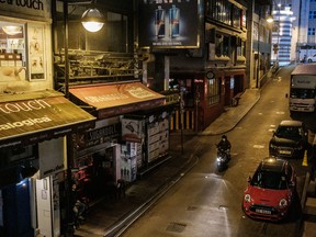 A motorcyclist rides through Lan Kwai Fong, a popular nightlife area, amid a coronavirus (COVID-19) outbreak on March 20, 2020 in Hong Kong, China. (Anthony Kwan/Getty Images)