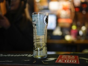 An empty pint glass sits on a bar before the coronavirus calls time on pubs on March 20, 2020 in Knutsford, Britain. (Christopher Furlong/Getty Images)