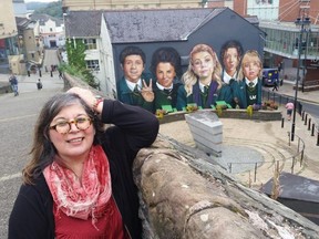 Rita DeMontis poses with the Derry Girls along the walled city of Derry.