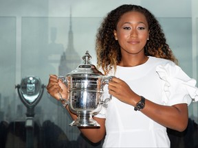 Naomi Osaka of Japan poses with the championship trophy at the Top of the Rock Observatory the day after winning the Women's Singles finals match against Serena Williams at the 2018 U.S. Open in the Manhattan borough of New York City, Sept. 9, 2018. (REUTERS/Caitlin Ochs/File Photo)
