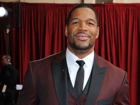 Michael Strahan poses on the red carpet for the 86th Academy Awards on March 2nd, 2014 in Hollywood, California.