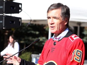 Jeff McCaig, Chairman of the Calgary Flames Foundation, speaks before a street hockey game with current and past grade six students to celebrate the Flames YMCA Grade 6 program in front of Eau Claire Market on Friday, Oct. 11, 2019.