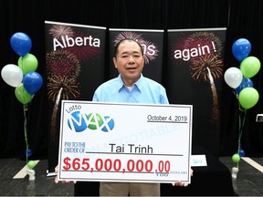Lottery winner Tai Trinh is presented with a giant cheque at a press conference in Calgary on Thursday, October 31, 2019 where he was introduced as a $65 million LOTTO MAX winner on the October 4 draw.