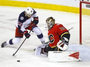 Calgary Flames goalie Cam Talbot battles Columbus Blue Jackets Emil Bemstrom in first period NHL action at the Scotiabank Saddledome in Calgary on Wednesday, March 4, 2020.