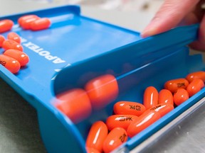 In this file photo taken on August 10, 2006, a pharmacist at the Toronto General Hospital's Immunodeficiency Clinic pharmacy dispences Kaletra, an AIDS drug known as a protease inhibitor, ahead of the International AIDS Conference in Toronto. (GEOFF ROBINS/AFP/Getty Images)