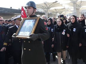 Turkish minister of Family, Labor and Social Services Zehra Zumrut Selcuk (4R) comforts the mother (3R) of slain Turkish soldier Halil Cankaya, who was killed in an airstrike in the Syrian town of Idlib, during the funeral ceremony in Ankara, Turkey, on March 1, 2020.