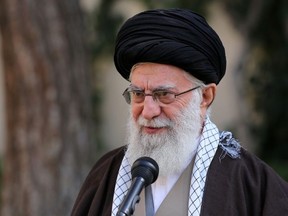 A handout picture provided by the office of Iran's Supreme Leader Ayatollah Ali Khamenei on March 3, 2020 shows him speaking in a microphone in a garden after a tree-planting ceremony marking the week of "Natural Resources" in the capital Tehran.