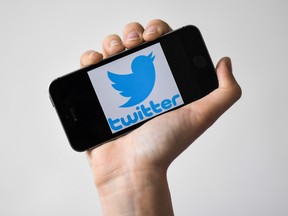 In this file photo taken on May 02, 2019 a woman shows a smartphone with the logo of US social network Twitter, in Nantes, western France.