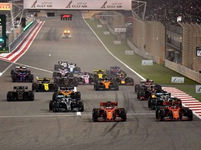 In this file photo taken on March 31, 2019, drivers steer their cars after the start of the Formula One Bahrain Grand Prix at the Sakhir circuit in the desert south of the Bahraini capital Manama.