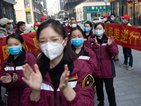 This photo taken on March 17, 2020 shows medical workers from Guizhou province being celebrated in a ceremony as they depart from Wuhan, in China's central Hubei province.