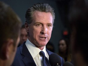 In this file photo California Governor Gavin Newsom speaks to the press in the spin room after the sixth Democratic primary debate of the 2020 presidential campaign season co-hosted by PBS NewsHour & Politico at Loyola Marymount University in Los Angeles, California on December 19, 2019.