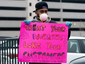 Jordan Flowers holds a sign at the Amazon building in the Staten Island borough of New York City March 30, 2020. (REUTERS/Jeenah Moon)