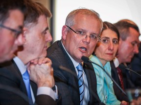In this file photo, Australian Prime Minister Scott Morrison (middle) speaks during a media conference at Parramatta Stadium, in western Sydney on March 13, 2020.(DAVID GRAY/AFP via Getty Images)