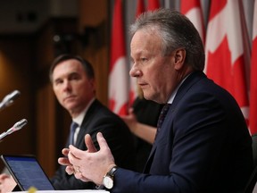 Bank of Canada Governor Stephen Poloz (right) and Finance Minister Bill Morneau speak during a news conference on Parliament Hill March 18, 2020 in Ottawa. (DAVE CHAN/AFP via Getty Images)
