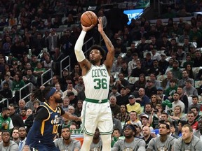 Boston Celtics guard Marcus Smart shoots the ball over Utah Jazz guard Mike Conley during the first half at TD Garden.