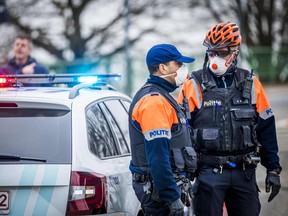 Flemish police stop Dutch motorists at the Belgian border at Maaseik on March 20, 2020. (MARCEL VAN HOORN/ANP/AFP via Getty Images)