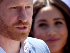 Britain's Prince Harry, Duke of Sussex, gives a speech as his wife Meghan, Duchess of Sussex, looks on, during a visit to the Youth Employment Services (YES) Hub in Tembisa township, near Johannesburg, South Africa, October 2, 2019.