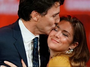 Prime Minister Justin Trudeau and his wife Sophie Gregoire Trudeau hug on stage after the federal election at the Palais des Congres in Montrea October 22, 2019. REUTERS/Carlo Allegri