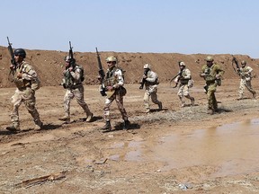 Coalition forces train Iraqi soldiers improve their skills during a military exercise at Camp Taji, north of Baghdad, Iraq, Monday, March 20, 2017. (THE CANADIAN PRESS/AP -Hadi Mizban)