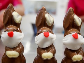 Chocolate Easter bunnies wearing protective masks are seen at Baeckerei Bohnenblust bakery in Bern, Switzerland March 25, 2020. (REUTERS/Arnd Wiegmann)