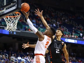 Clemson Tigers guard Al-Amir Dawes (left) shoots the ball against Miami Hurricanes guard Isaiah Wong (right) during second half ACC Tournament action at Greensboro Coliseum, in Greensboro, N.C., on Wednesday, March 11, 2020.
