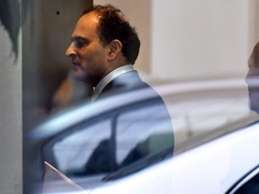 David Sidoo, of Vancouver, enters an adjacent building with his lawyer following a federal court hearing Friday, March 15, 2019, in Boston. Sidoo faced charges of conspiracy to commit mail and wire fraud as part of a wide-ranging college admissions bribery scandal.