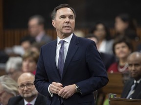 Finance Minister Bill Morneau rises during Question Period in the House of Commons Wednesday, March 11, 2020 in Ottawa.