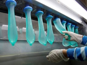 A worker performs a test on condoms at Malaysia's Karex factory in Pontian, November 7, 2012. (REUTERS/Bazuki Muhammad/File Photo)