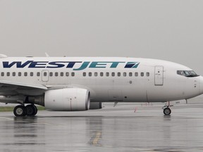A WestJet airlines plane at the Ottawa airport Wednesday June 26, 2019.