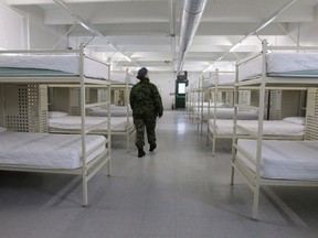 A member of the Canadian Armed Forces walk inside one of the barracks at CFB Trenton in Trenton, Ont., on December 1, 2015.