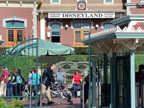 In this file photo, people visit Disneyland on January 22, 2015 in Anaheim, California. (FREDERIC J. BROWN/AFP via Getty Images)