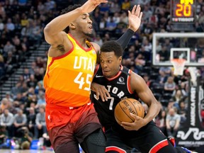 Raptors guard Kyle Lowry (right) drives to the basket against Jazz guard Donovan Mitchell (left) during first quarter NBA action at Vivint Smart Home Arena in Salt Lake City, on March 9, 2020.