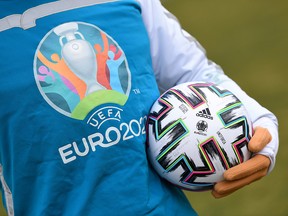 Euro 2020 mascot Skillzy poses for a photo with the official match ball at Olympiapark in Munich, Germany, March 3, 2020. (REUTERS/Andreas Gebert/File Photo)