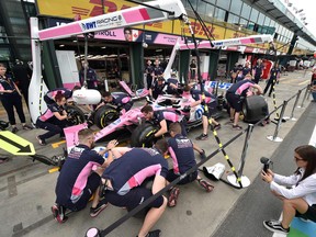 The Racing Point team practices pitstops before the first practice session for the Formula One Australian Grand Prix in Melbourne on March 13, 2020. (PETER PARKS/AFP via Getty Images)