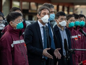 Vice President of Lombardy Region Fabrizio Sala (centre) talks to the media as he welcomes members of a Chinese Anti-Epidemic medical expert team pose for a photograph after landing at Milan - Malpensa airport on in Ferno, Italy, Wednesday, March 18, 2020.