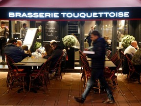 People enjoy dinner and drinks, after the French Prime Minister announcement that the shut down of non-essential commerce and places will start in France at midnight, in le Touquet, France, Saturday, March 14, 2020.