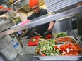 German chef Max Strohe of the Michelin-starred Tulus Lotrek restaurant prepares meals for healthcare workers in Berlin March 23, 2020. (REUTERS/Hannibal Hanschke)