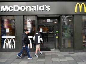 Two members of the public make their way into a McDonald's restaurant that will only be offering takeaways due to the coronavirus on March 19, 2020 in Plymouth, U.K. (Dan Mullan/Getty Images)