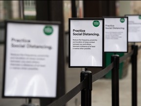 Signs explaining the need for social distancing while queueing are seen outside a branch of the Whole Foods health store on March 30, 2020 in London, England. (Leon Neal/Getty Images)